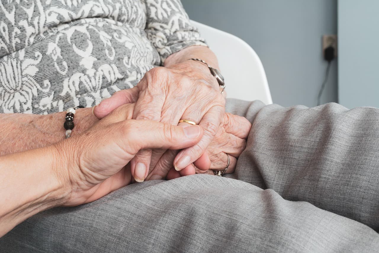 Older person's hands on textured surface