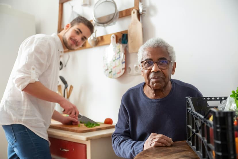 Caregiver assisting older person in kitchen